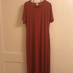 Long red dress with short sleeves.